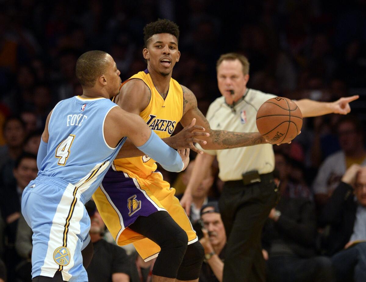 Lakers forward Nick Young takes on Denver guard Randy Foye (4) on Feb. 10.