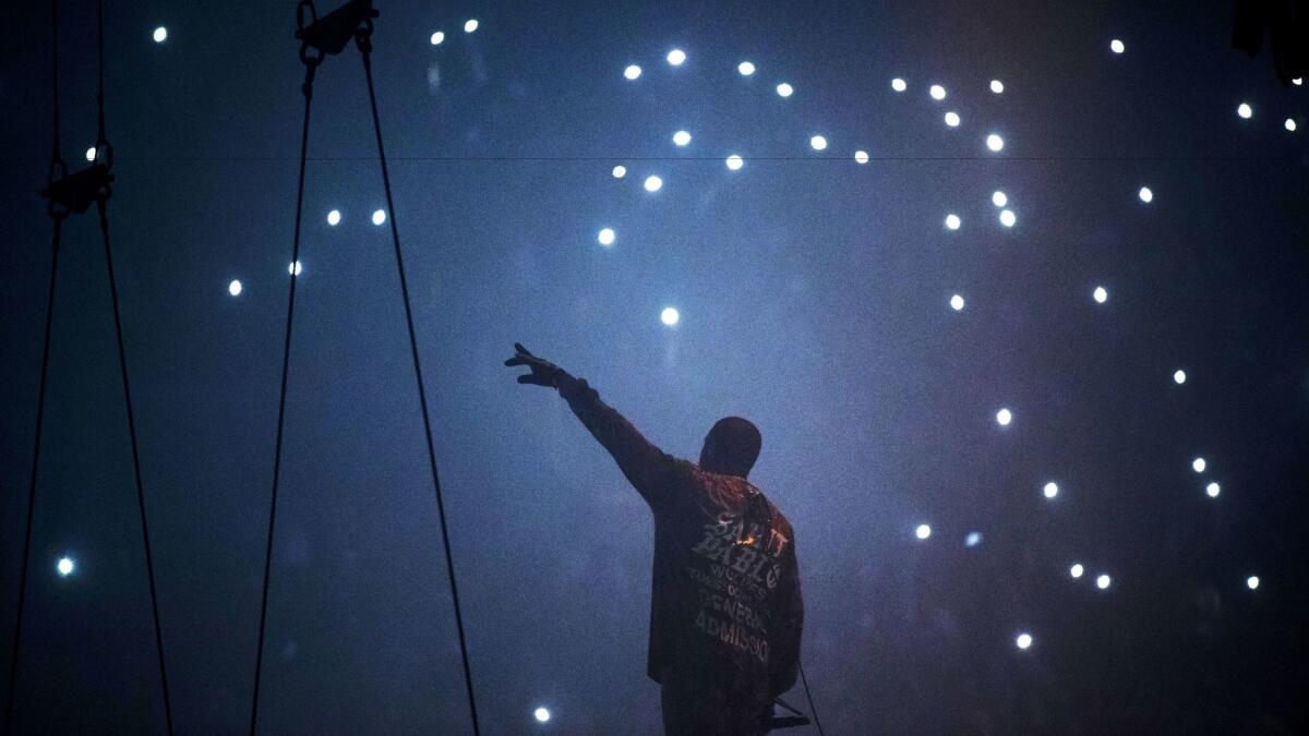 Kanye West performs at the Forum earlier this year.