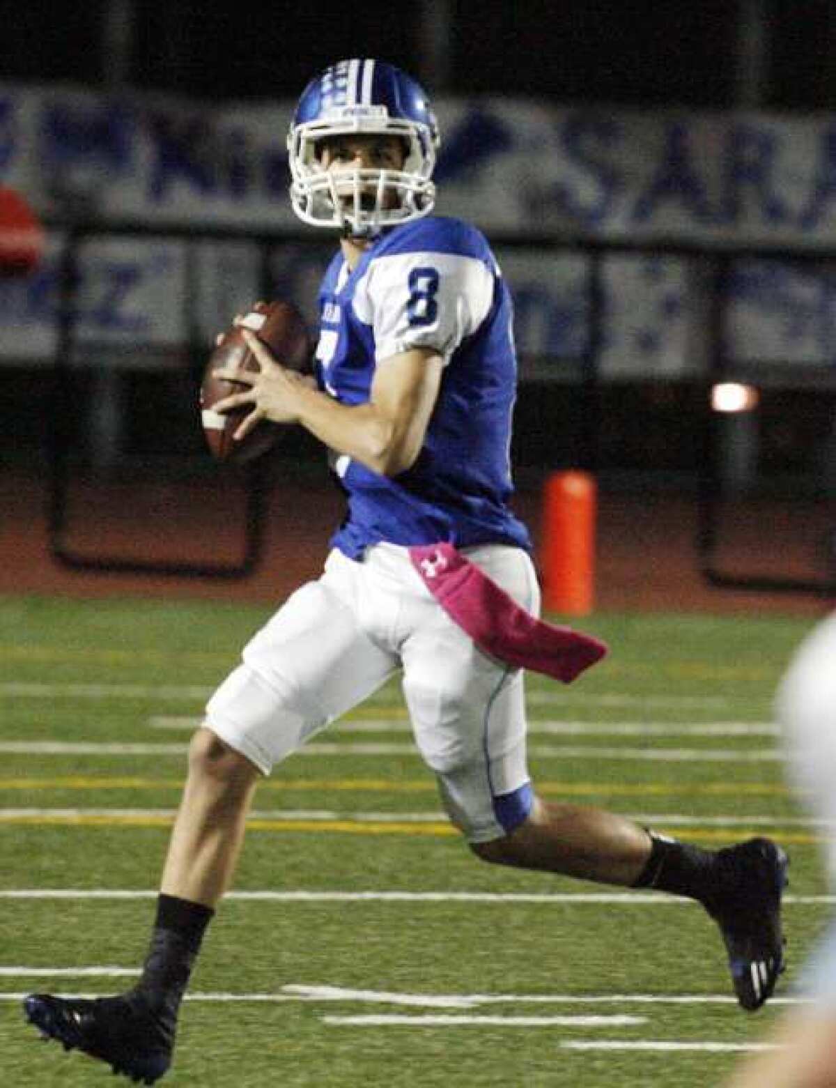Burbank quarterback Ryan Meredith rolls out to pass against Crescenta Valley.