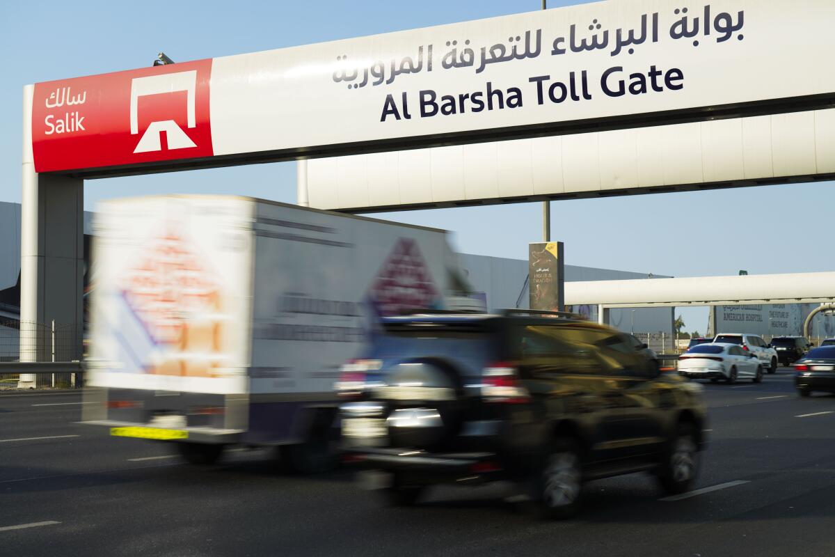 Vehicles pass under a Salik toll gate on Sheikh Zayed Road in Dubai, United Arab Emirates, Monday, Sept. 5, 2022. Dubai toll gate operator Salik announced Monday it will make an initial public offering on the city-state's stock market, becoming the latest state-linked company to list. (AP Photo/Jon Gambrell)