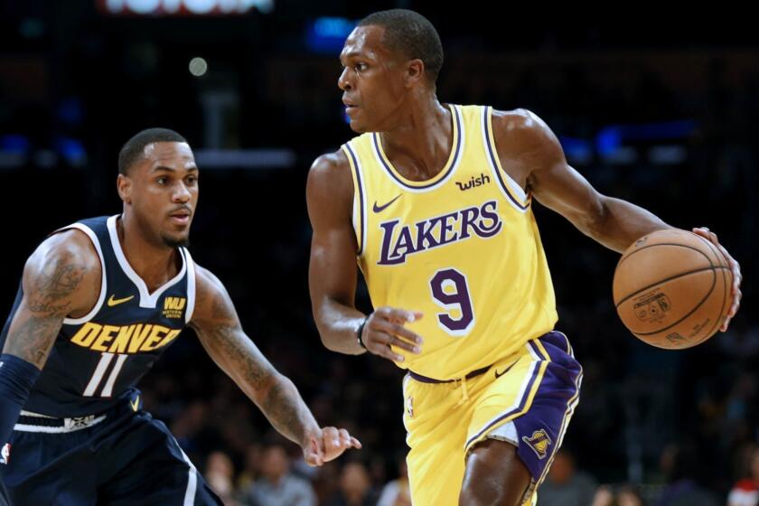LOS ANGELES, CALIF. -- TUESDAY, OCTOBER 2, 2018: Los Angeles Lakers guard Rajon Rondo (9) is defended by Denver Nuggets guard Monte Morris (11) in the first half at the Staples Center in Los Angeles, Calif., on Oct. 2, 2018. (Gary Coronado / Los Angeles Times)