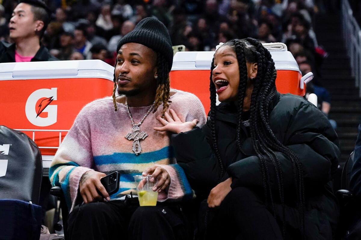 Rapper DDG and singer Halle Bailey attend a sporting event