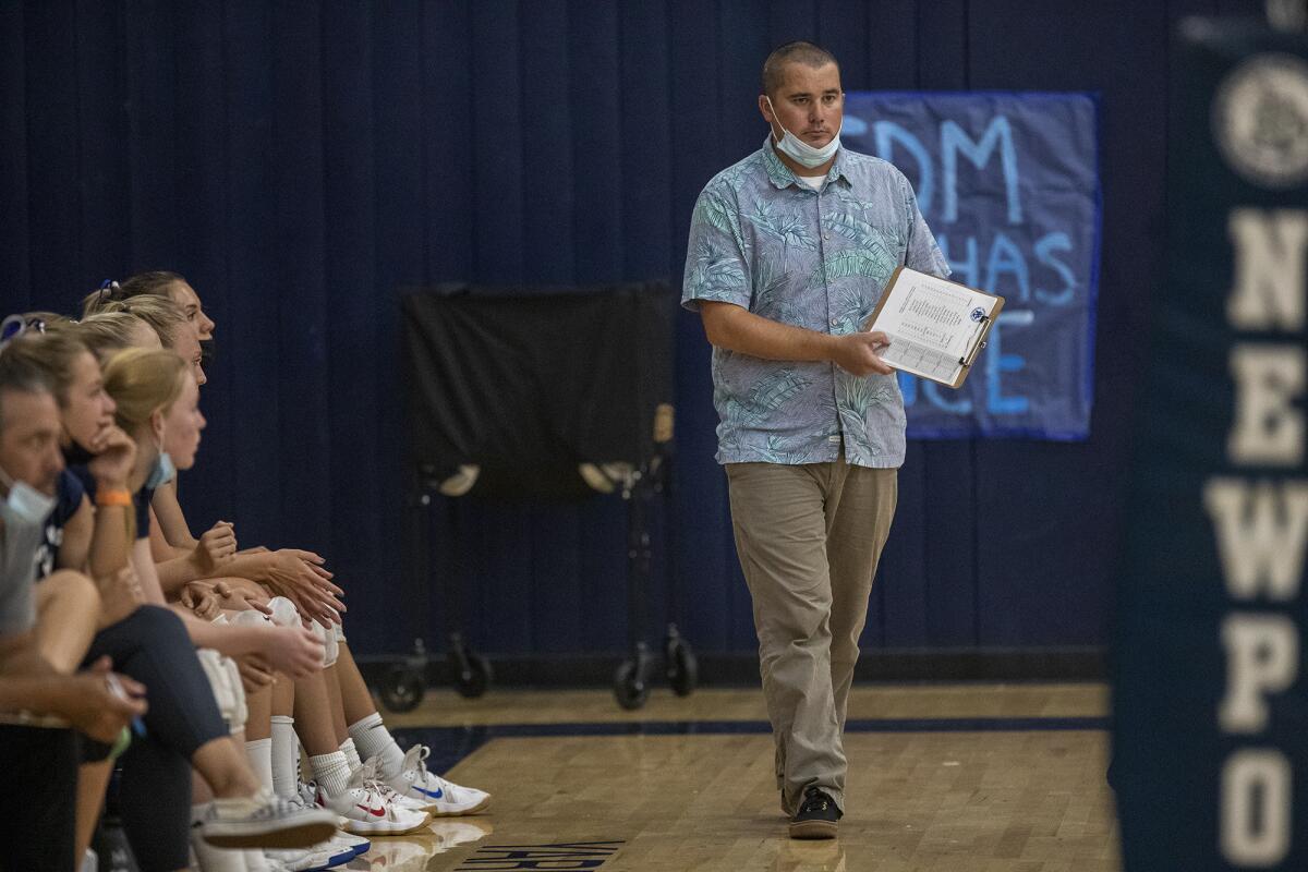 Newport Harbor's Andrew Mabry gives instructions to his team during the Battle of the Bay girls' volleyball match.