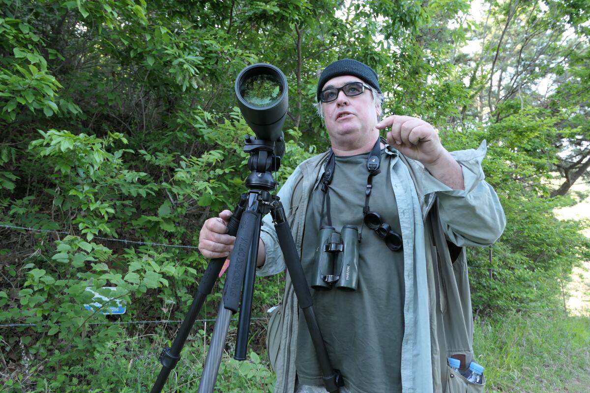 Nial Moores, 56, a British birder and conservationist, surveys birds on Baekryeong, South Korea's northernmost island, about 10 miles from North Korea's west coast, in late May. Moores has been making trips in recent years to North Korea to study birds and promote conservation efforts there.