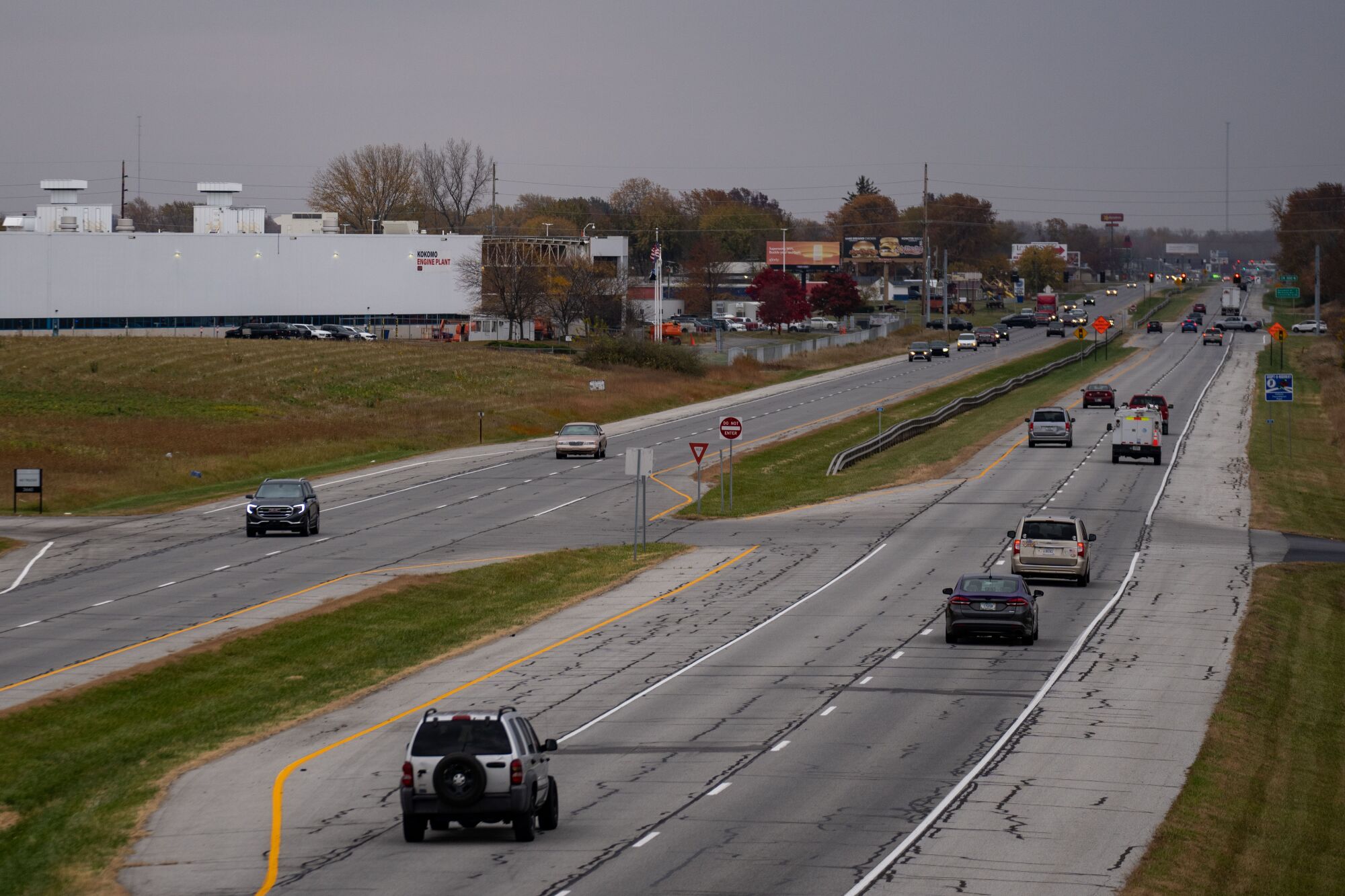 Vehicles on a road near buildings 