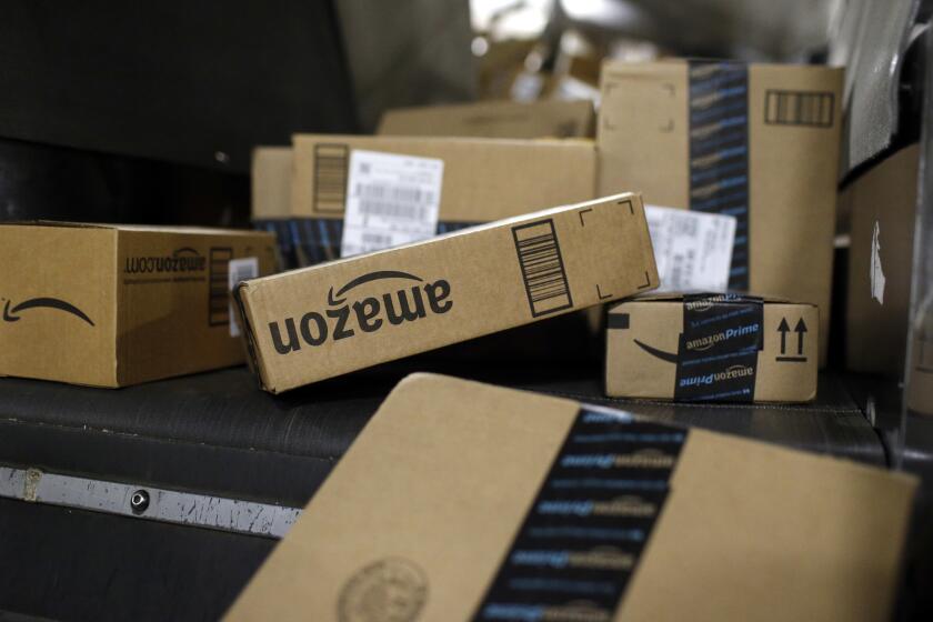 FILE- In this Nov. 20, 2015, file photo, packages being shipped in Amazon boxes ride a conveyor belt at the UPS Worldport hub in Louisville, Ky. Amazon is following Target and temporarily dropping the minimum amount shoppers need to spend to qualify for free shipping. Typically, Amazon shoppers need to spend $25 to qualify for free shipping or pay $119 a year for a Prime membership. Amazon's offer, which started Monday, Nov. 5, 2018, applies to hundreds of millions of items and on orders that arrive in time for Christmas. (AP Photo/Patrick Semansky, File)