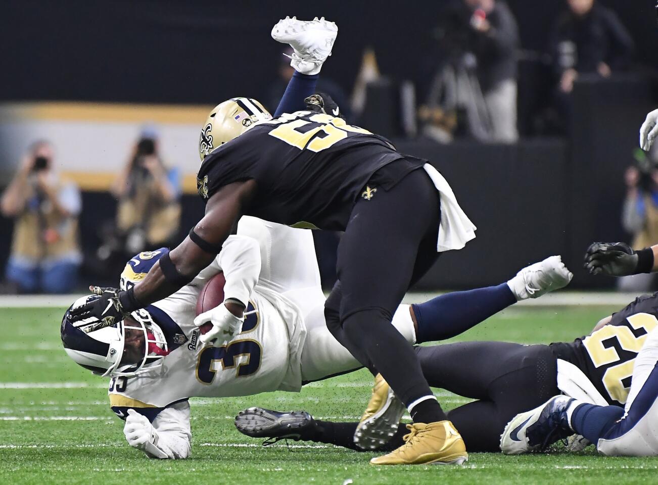 Rams running back C.J. Anderson is upended by the New Orleans Saints defense in the third quarter in the NFC Championship at the Superdome in New Orleans Sunday.