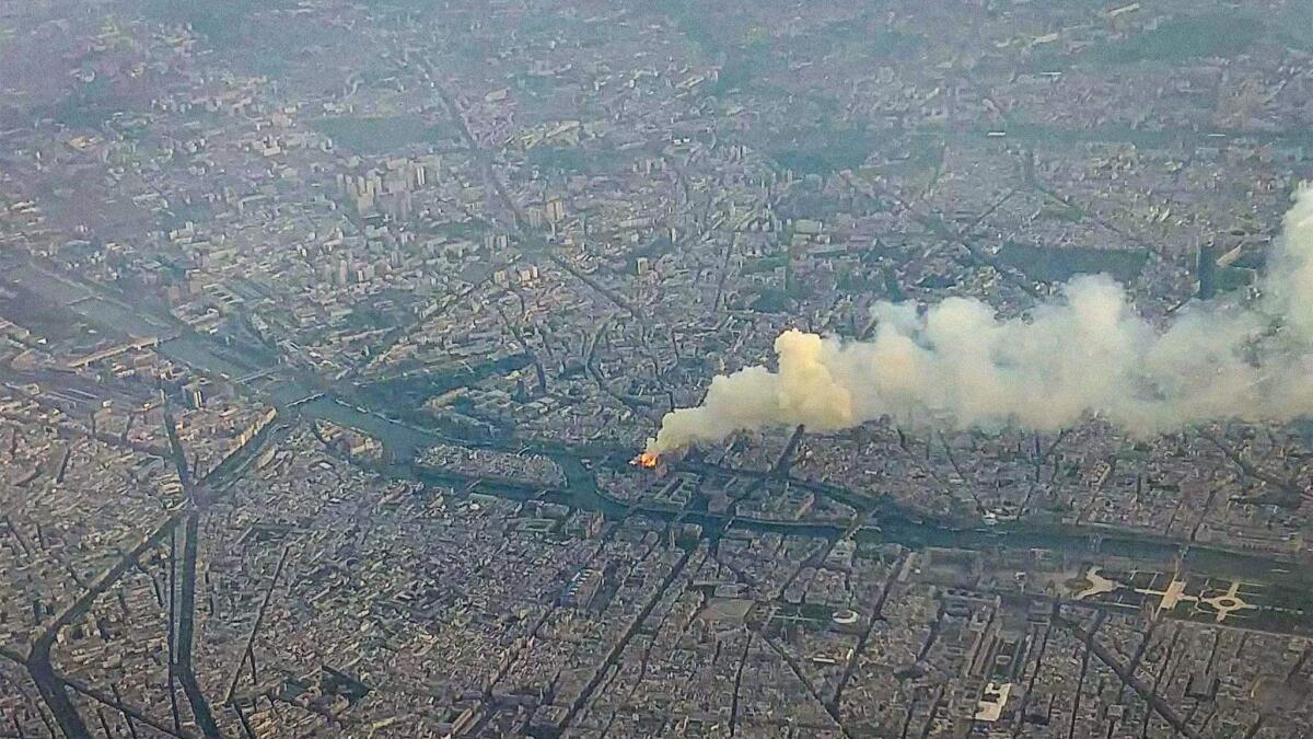 Smoke and flame rise from Notre Dame as seen from high above on April 15.