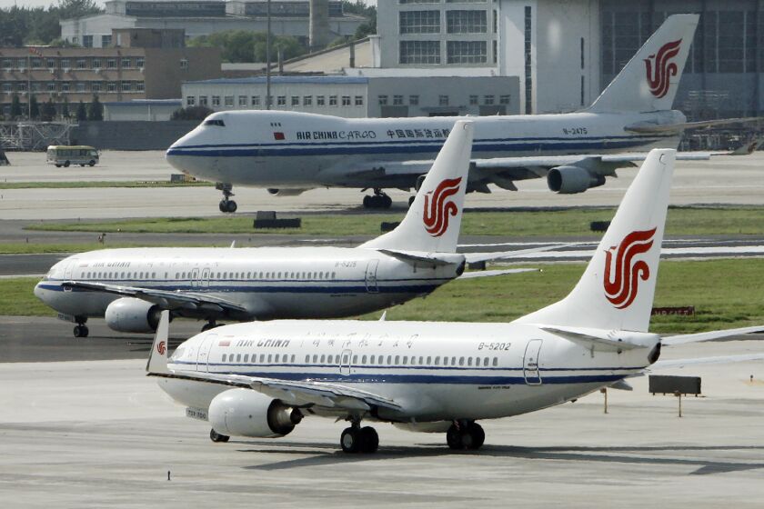 FILE - Air China planes sit on the tarmac at Beijing Airport in Beijing, China on Aug. 20, 2009. The U.S. government is suspending 26 flights by Chinese airlines from the United States to China in a dispute over anti-virus controls after Beijing suspended flights by American carriers. (AP Photo/Greg Baker, File)