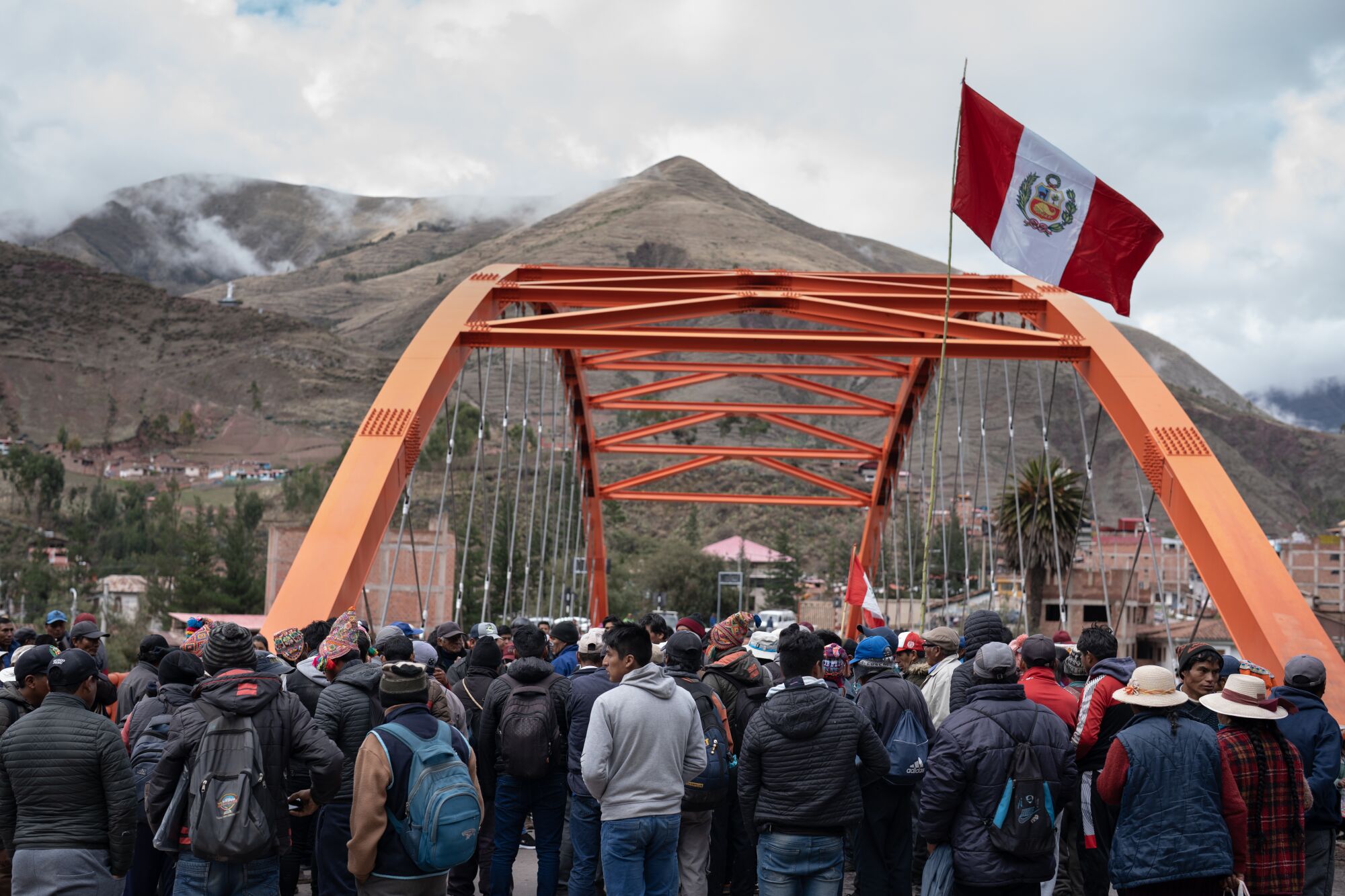 Protesters block a bridge in Urcos, Peru