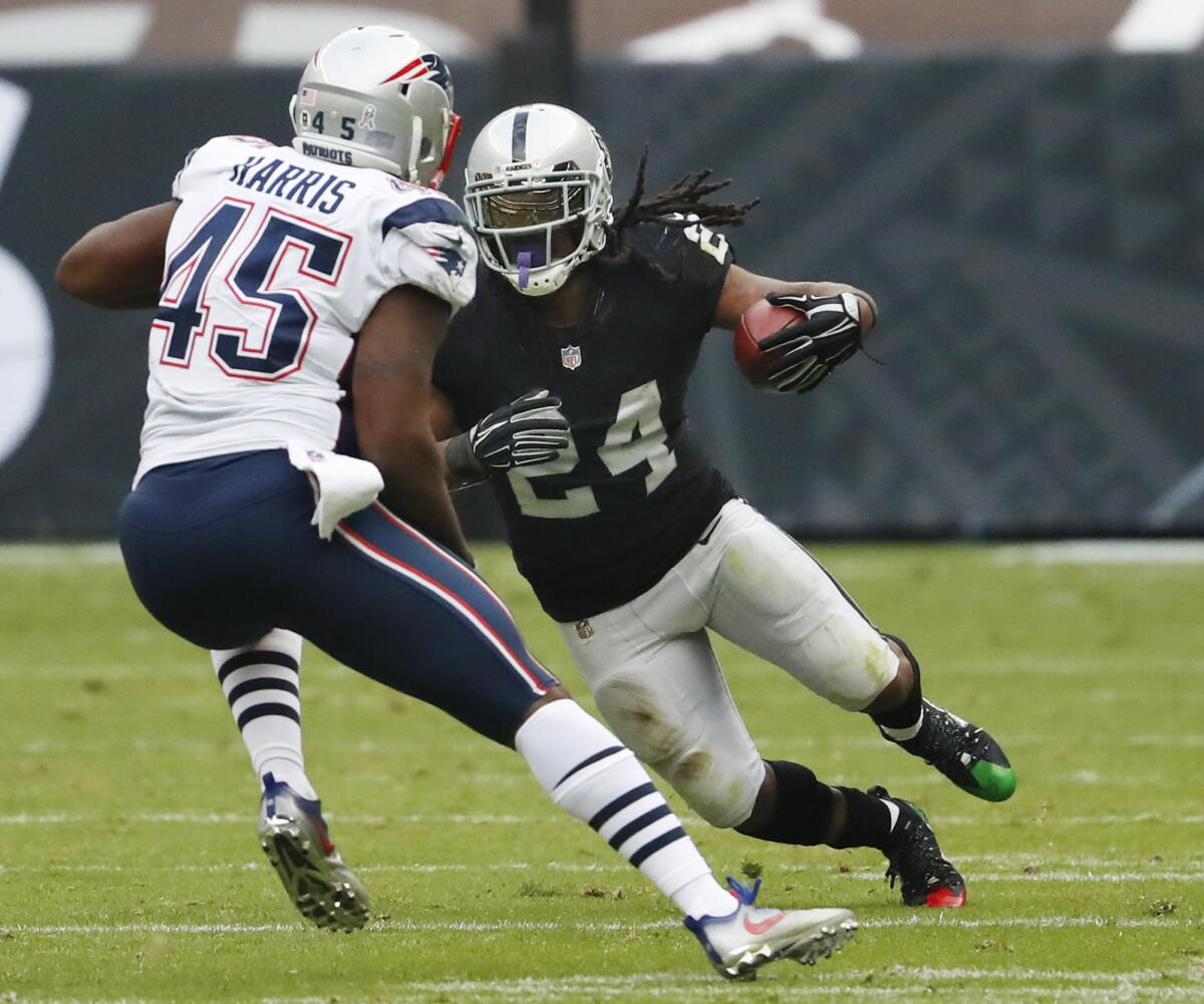 Oakland Raiders running back Marshawn Lynch rushes against New England Patriots linebacker David Harris during a game in Mexico City on Nov. 19.