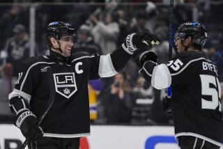 Kings center Anze Kopitar celebrates with right wing Quinton Byfield after the team's win over the Columbus Blue Jackets 
