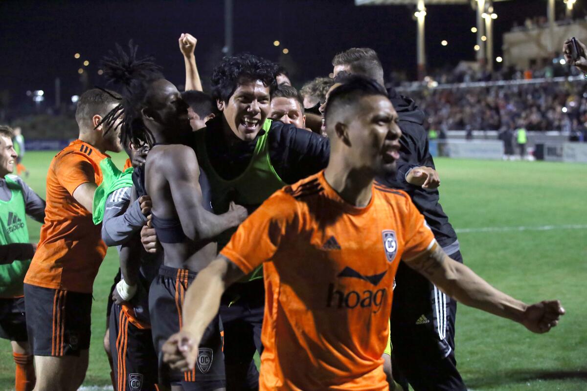 Orange County Soccer Club players celebrate after winning the Western Conference semifinals of the USL Championship.