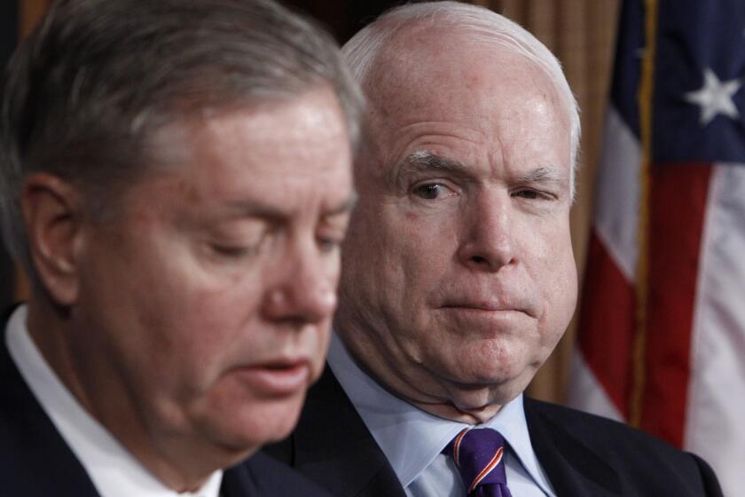 Sen. John McCain (R-Ariz.), right, listens as Sen. Lindsey Graham (R-S.C.) discusses the investigation of the deadly Sept. 11 attack on the U.S. consulate in Benghazi during a news conference on Capitol Hill.