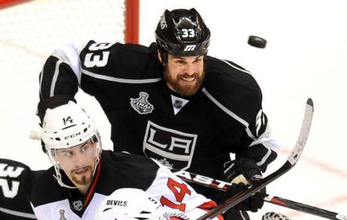 Willie Mitchell of the Kings battles for position with Adam Henrique of the Devils in Game 3.