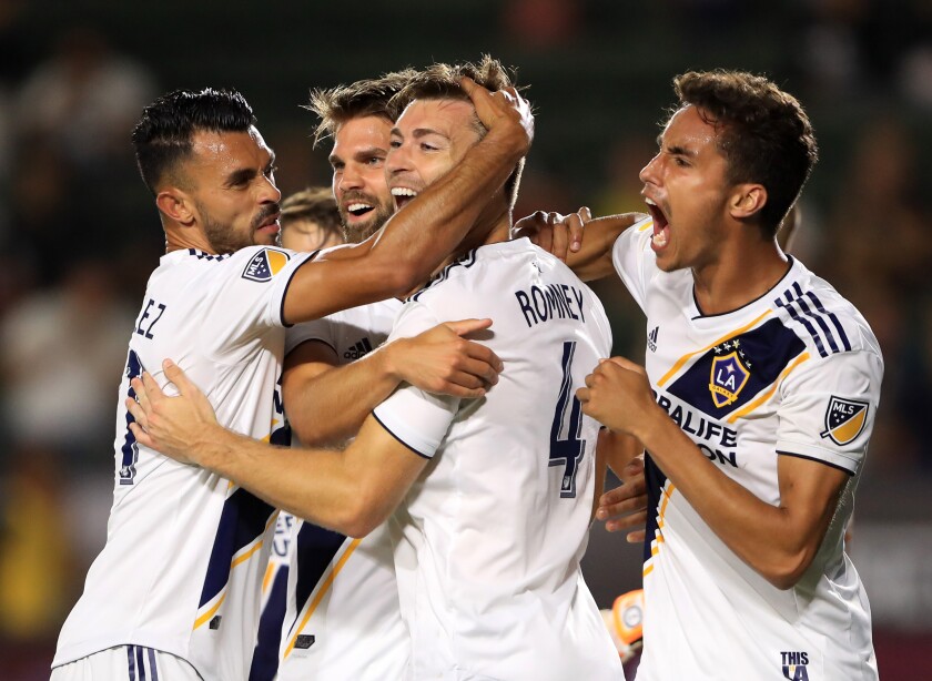 Galaxy's Dave Romney (4) is congratulated after scoring a goal by Ethan Zubak (29) , Efrain Alvarez (26) and Emil Cuello (27) during the second half of the quarterfinal match against Tijuana of the 2019 Leagues Cup at Dignity Health Sports Park on Tuesday.