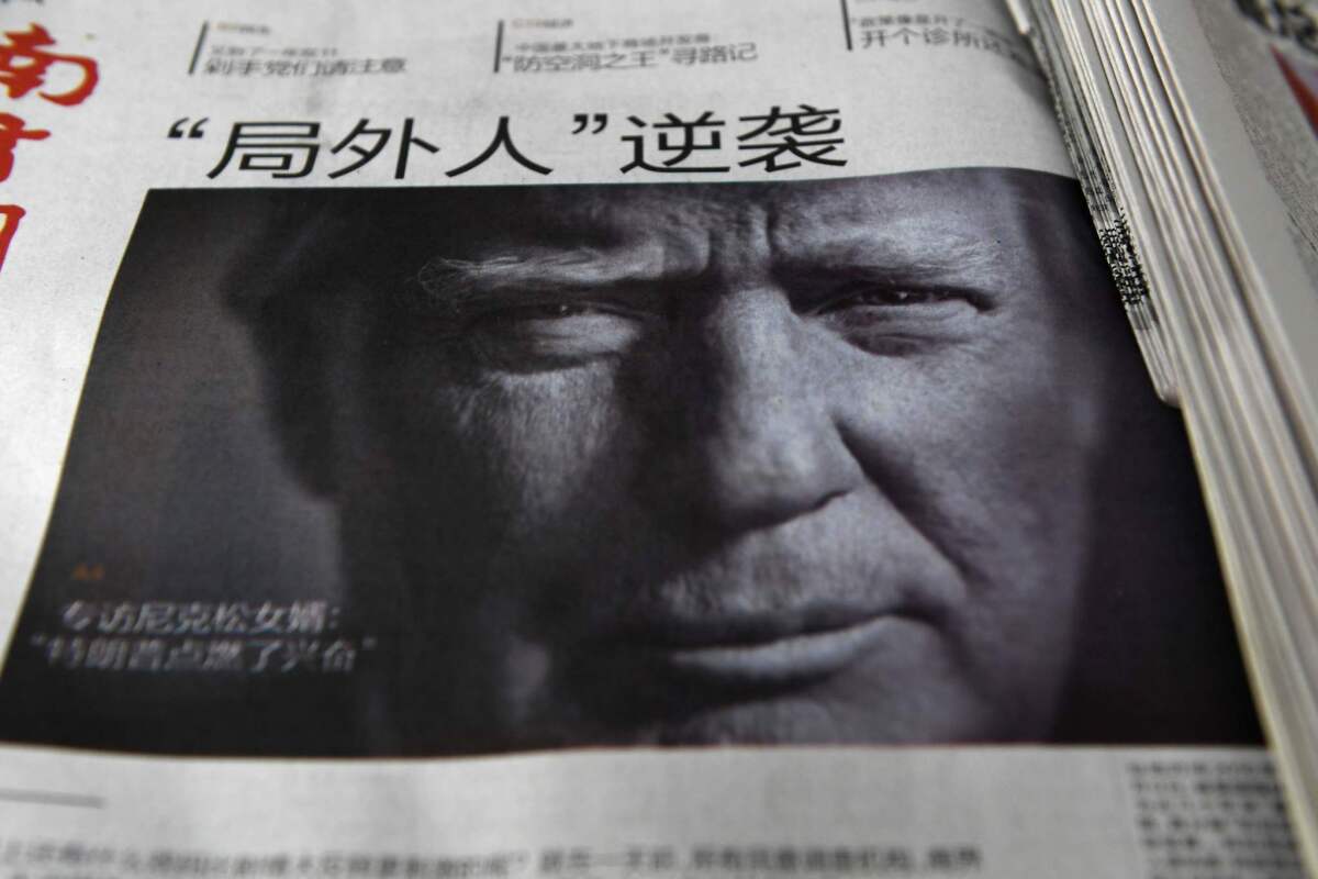 This file photo taken on November 10, 2016 shows a newspaper featuring a photo of President-elect Donald Trump at a news stand in Beijing.