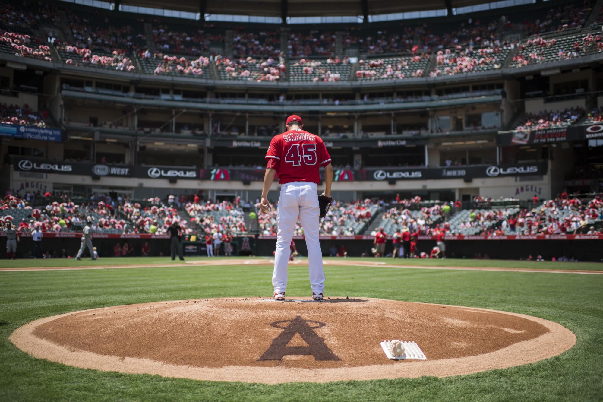 The late pitcher Tyler Skaggs stands on the mound in red jersey, No. 45, before a 2016 game at Angel Stadium