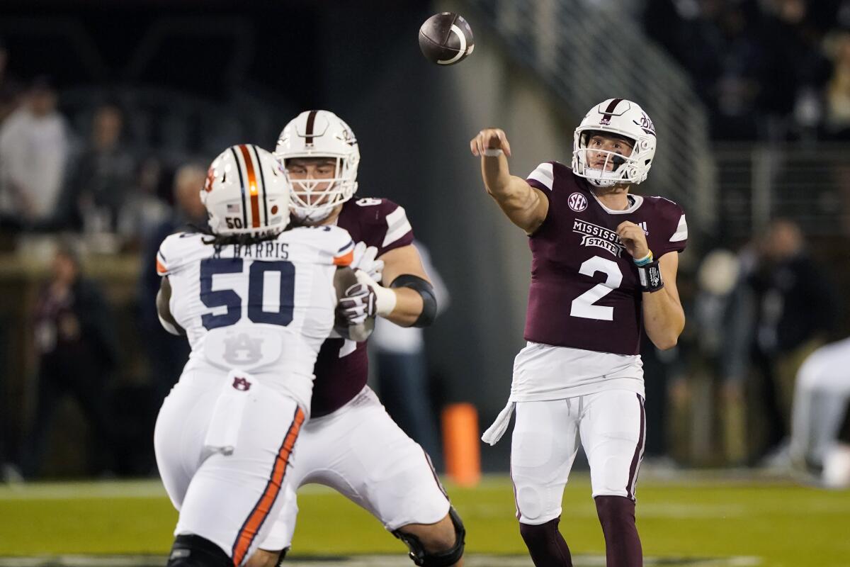 Mississippi State quarterback Will Rogers (2) throws a pass as Auburn defensive lineman Marcus Harris (50) is blocked during the second half of an NCAA college football game in Starkville, Miss., Saturday, Nov. 5, 2022. Mississippi State won 39-33. (AP Photo/Rogelio V. Solis)