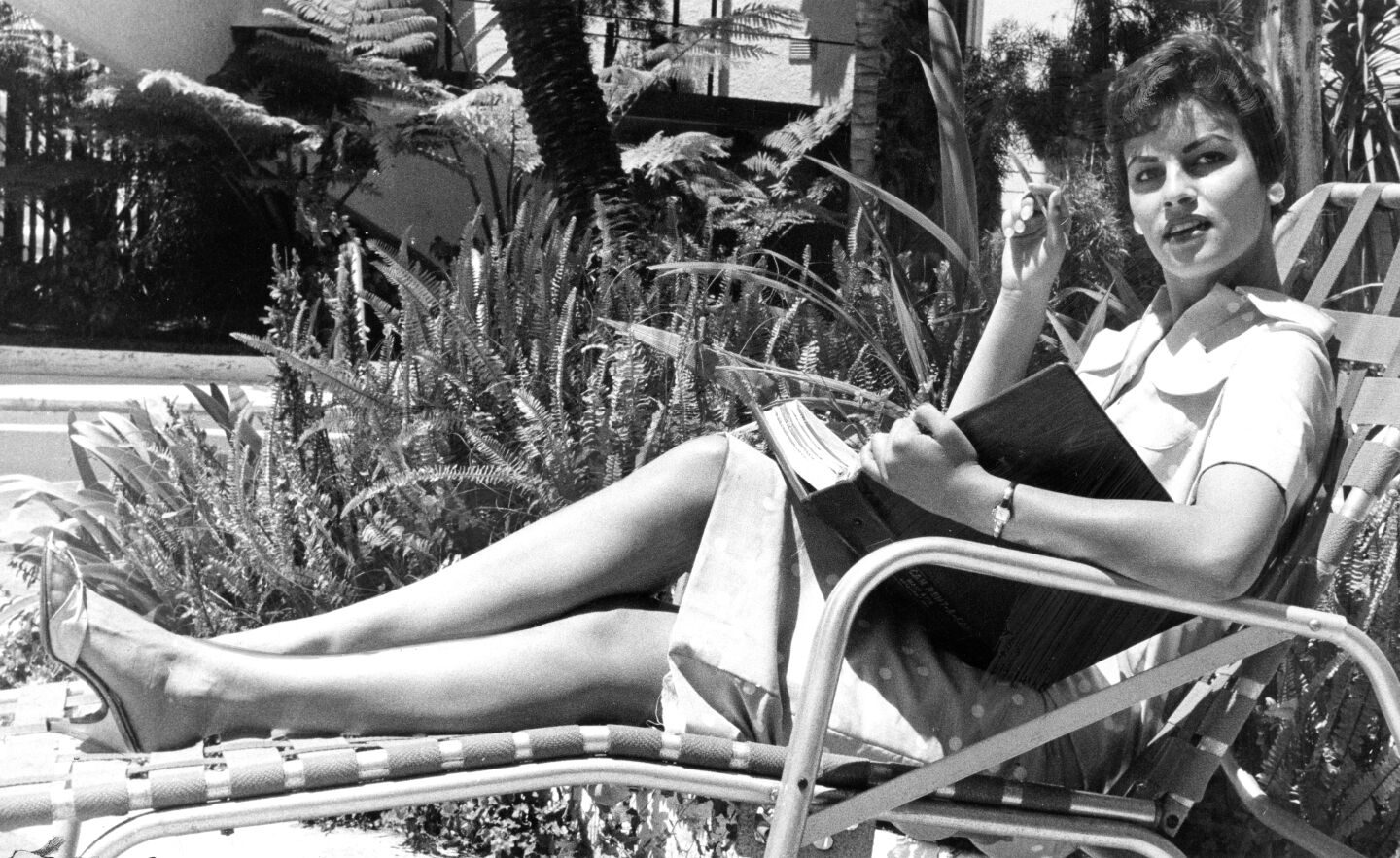 Raquel Tejada of La Jolla is shown in June 1958 relaxing in a lounge chair reading a script.
