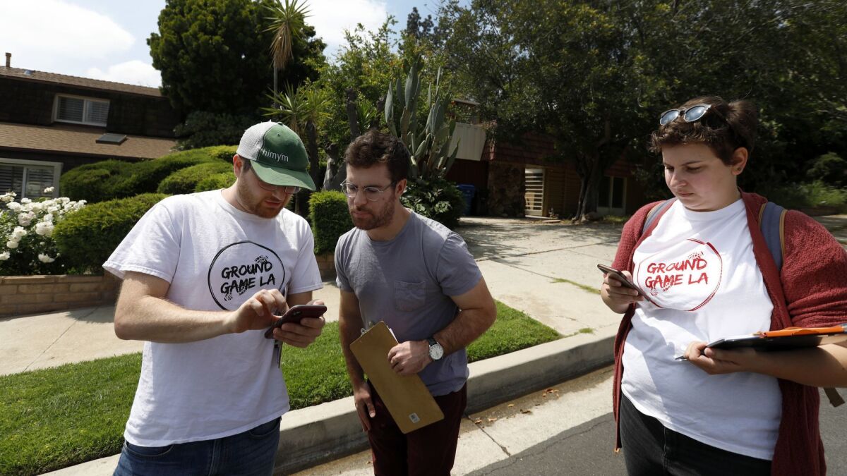 Jesse Alson-Milkman, 37, from left, Ian Carr, 28, and Brooke Jacobovitz, 25, canvass for L.A. City Council candidate Loraine Lundquist in Granada Hills on May 11.