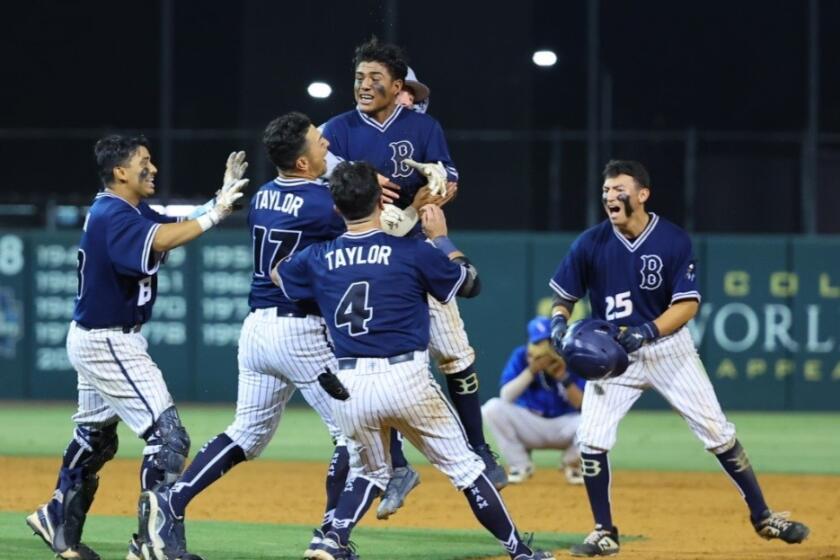 Birmingham's Johan Ceja gets surrounded by teammates after delivering walk-off hit for 2-1 win over El Camino Real.