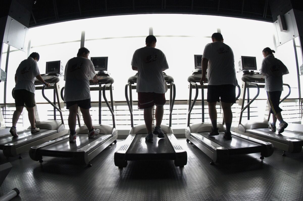 Students hit the treadmill at a gym in China. Researchers in Sweden have found that exercise can help ward off depression in those under stress.