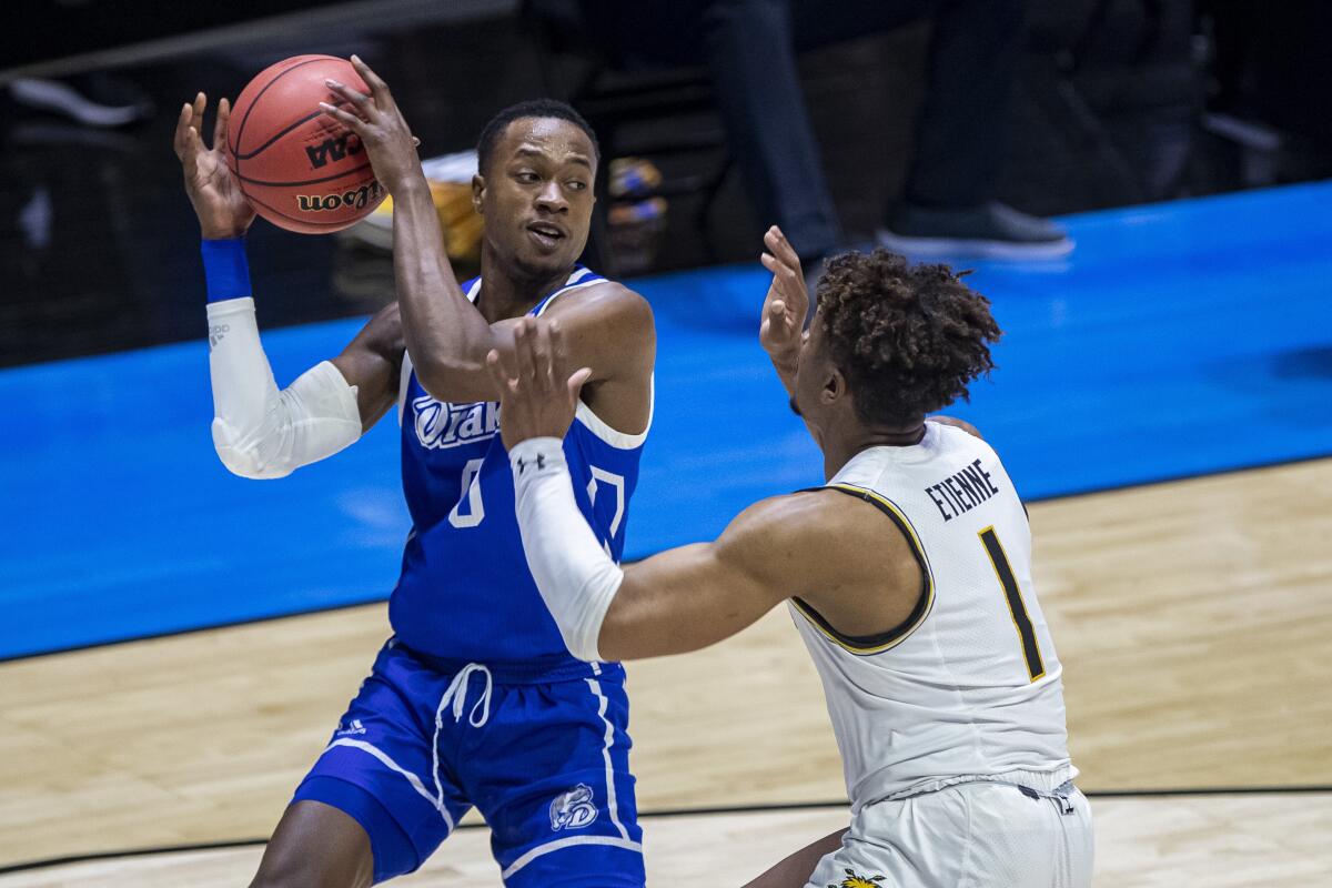 Drake's D.J. Wilkins is defended by Wichita State's Tyson Etienne during the first half of Drake's 53-52 win Thursday.