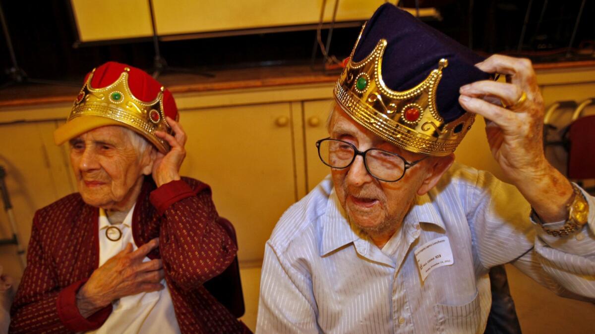 Virginia Davis, then 104 years old, and Paul Cooks, then 103, at a gathering of centenarians. A new study finds that mortality rates stop accelerating around age 80 and may reach a plateau around age 105.