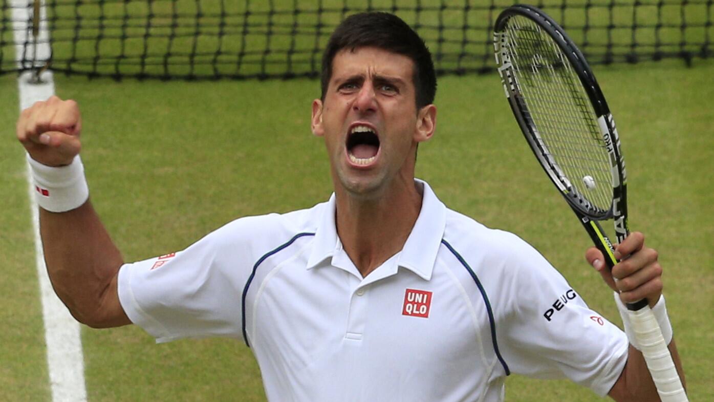 Novak Djokovic celebrates after defeating Roger Federer for the men's singles title at Wimbledon on July 12, 2015.