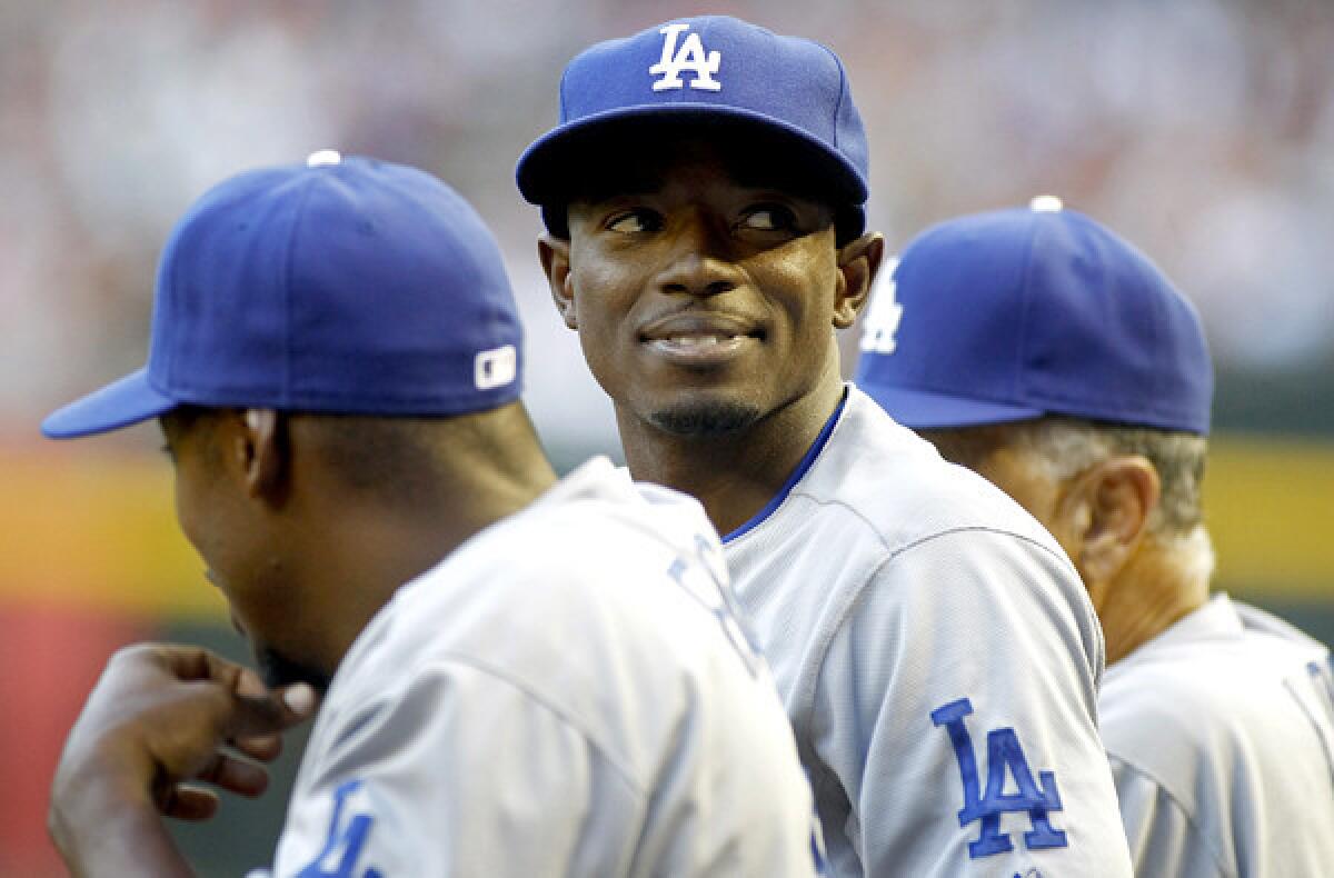 Dodgers second baseman Dee Gordon chats with a teammate in the dugout during the top of the third inning on Sunday in Phoenix. He stole four bases in that single game.