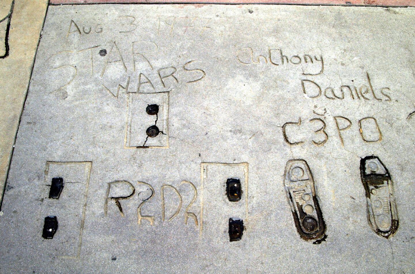 The prints of "Star Wars" droids R2-D2 (played by Kenny Baker) and C-3PO (played by Anthony Daniels) are seen outside Grauman's Chinese Theatre on March 16, 2003, in Hollywood.