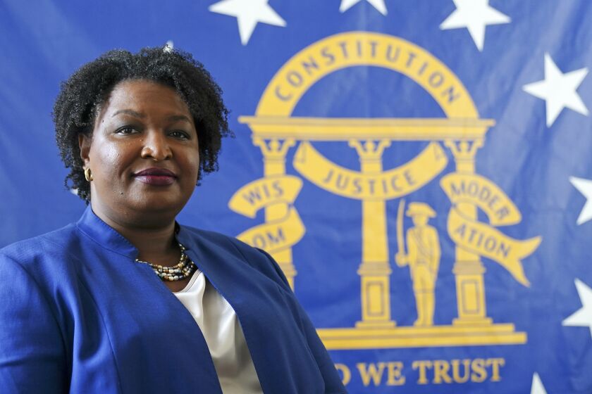 FILE - Democratic candidate for Georgia governor Stacey Abrams poses for a portrait in front of the State Seal of Georgia on Aug. 8, 2022, in Decatur, Ga. Abrams founded Fair Fight Action, a group focused on fair elections, that filed a wide-ranging federal lawsuit alleging “gross mismanagement” of Georgia’s elections. That lawsuit sputtered out Friday, Sept. 30, with Fair Fight losing its last remaining arguments, more than a year after the judge had tossed most earlier claims. (AP Photo/John Bazemore, File)