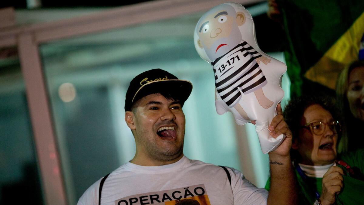 A demonstrator in Rio de Janeiro celebrates the conviction of former Brazilian President Luiz Inacio Lula da Silva on corruption charges.