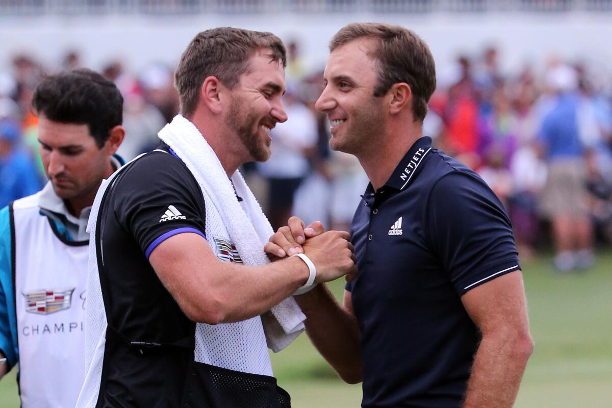 Dustin Johnson, right, is congratulated by his brother, and caddie, Austin Johnson after winning the Cadillac Championship on Sunday.