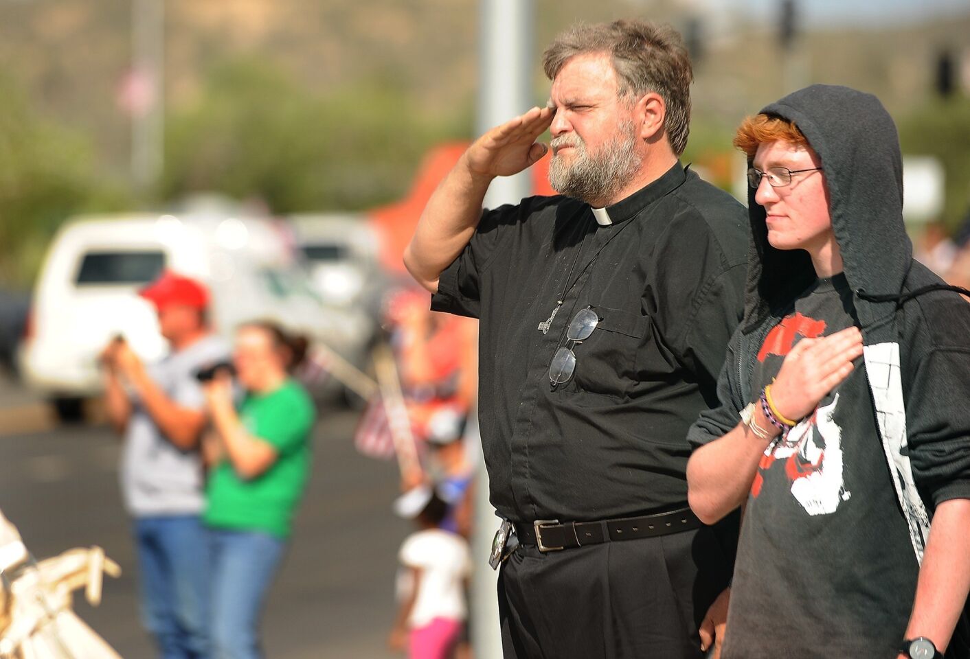 People in Prescott pay their respects as the procession travels through town.