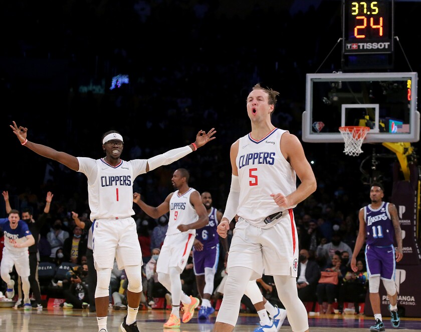 Clippers guard Luke Kennard (5) celebrates after making a three-pointer against the Lakers.
