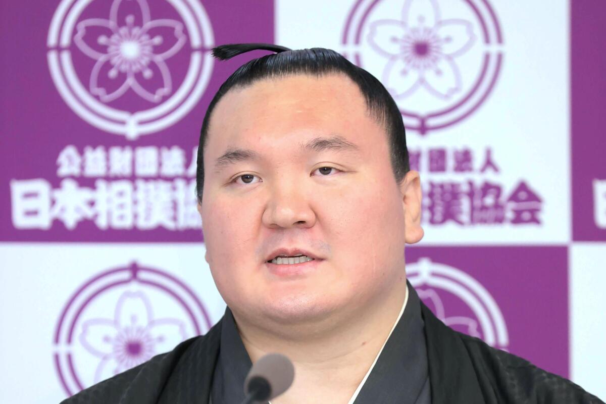 Hakuho speaks at a press conference to announce his retirement at Ryogoku Kokugikan Stadium in Tokyo Friday, Oct. 1, 2021. Mongolia-born Hakuho was famous for his diligent training that led him to be the sumo grand champion, or Yokozuna, with victories in a record-45 tournaments. (Kyodo News via AP)