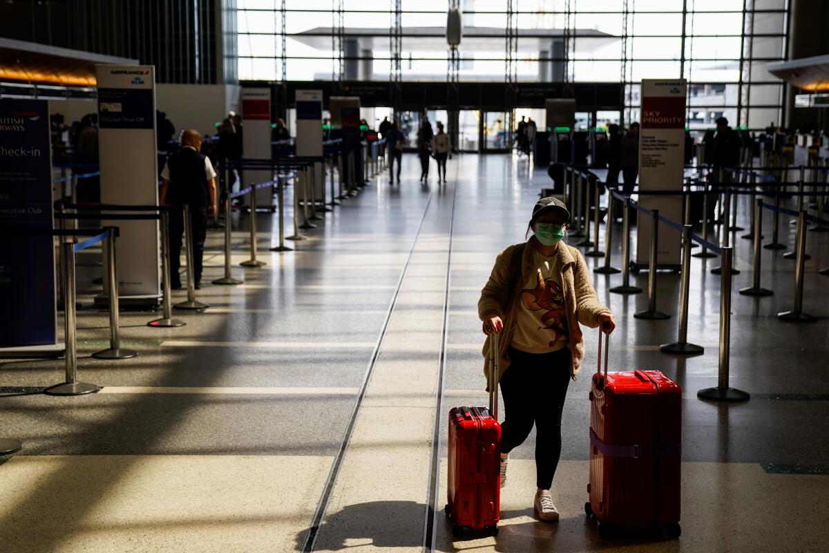 Travelers at the Tom Bradley International Terminal at Los Angeles International Airport on March 18, 2020. 