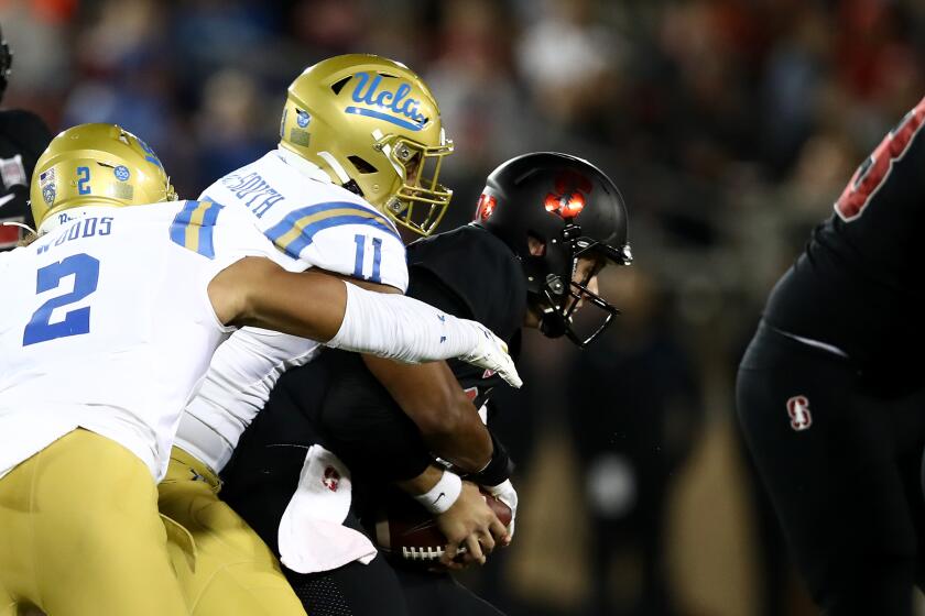 PALO ALTO, CALIFORNIA - OCTOBER 17: Keisean Lucier-South #11 of the UCLA Bruins sacks Jack West #10 of the Stanford Cardinal at Stanford Stadium on October 17, 2019 in Palo Alto, California. (Photo by Ezra Shaw/Getty Images) ** OUTS - ELSENT, FPG, CM - OUTS * NM, PH, VA if sourced by CT, LA or MoD **