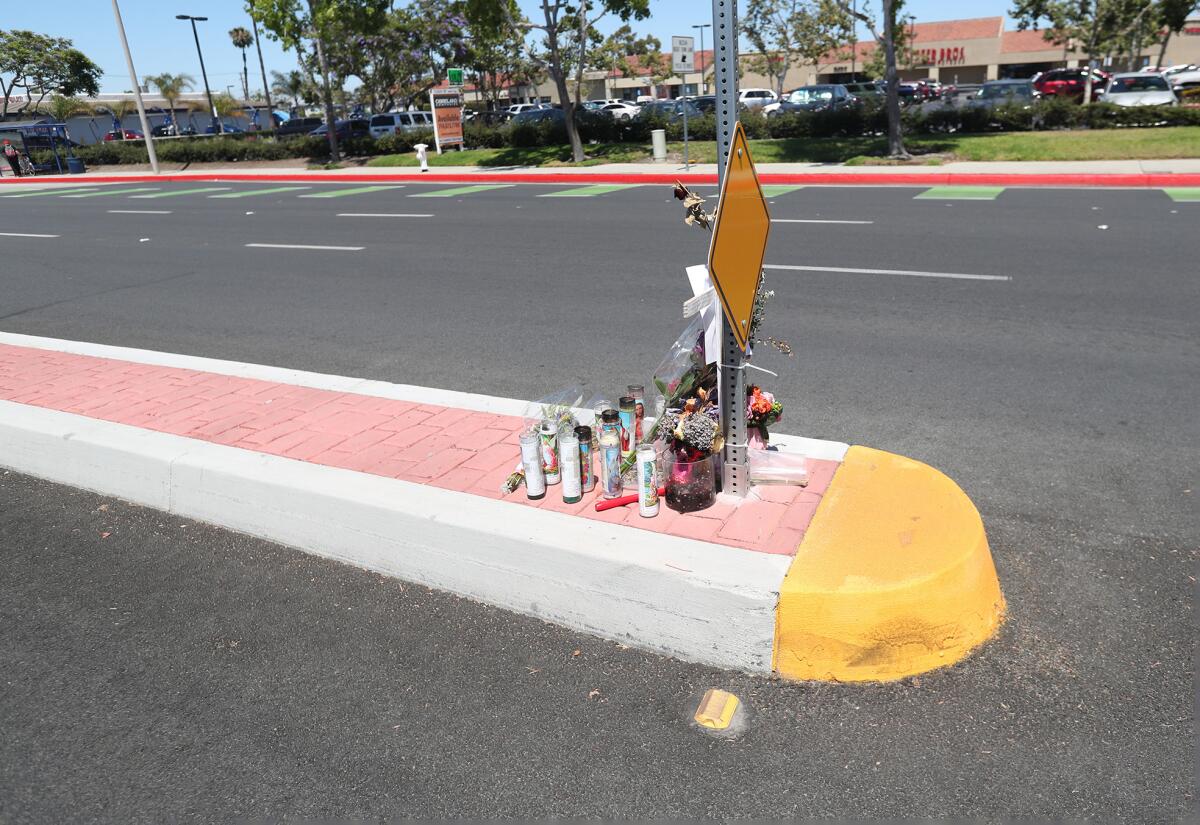A memorial on Costa Mesa's Fairview Road marks where Linda Lefler, 64, was killed on June 15 by a hit-and-run driver.