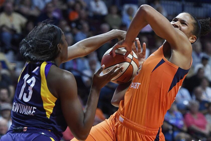 Los Angeles Sparks center Chiney Ogwumike, left, blocks a shot attempt by Connecticut Sun forward Alyssa Thomas during the second half of a WNBA basketball game Thursday, June 6, 2019, in Uncasville, Conn. (Sean D. Elliot/The Day via AP)