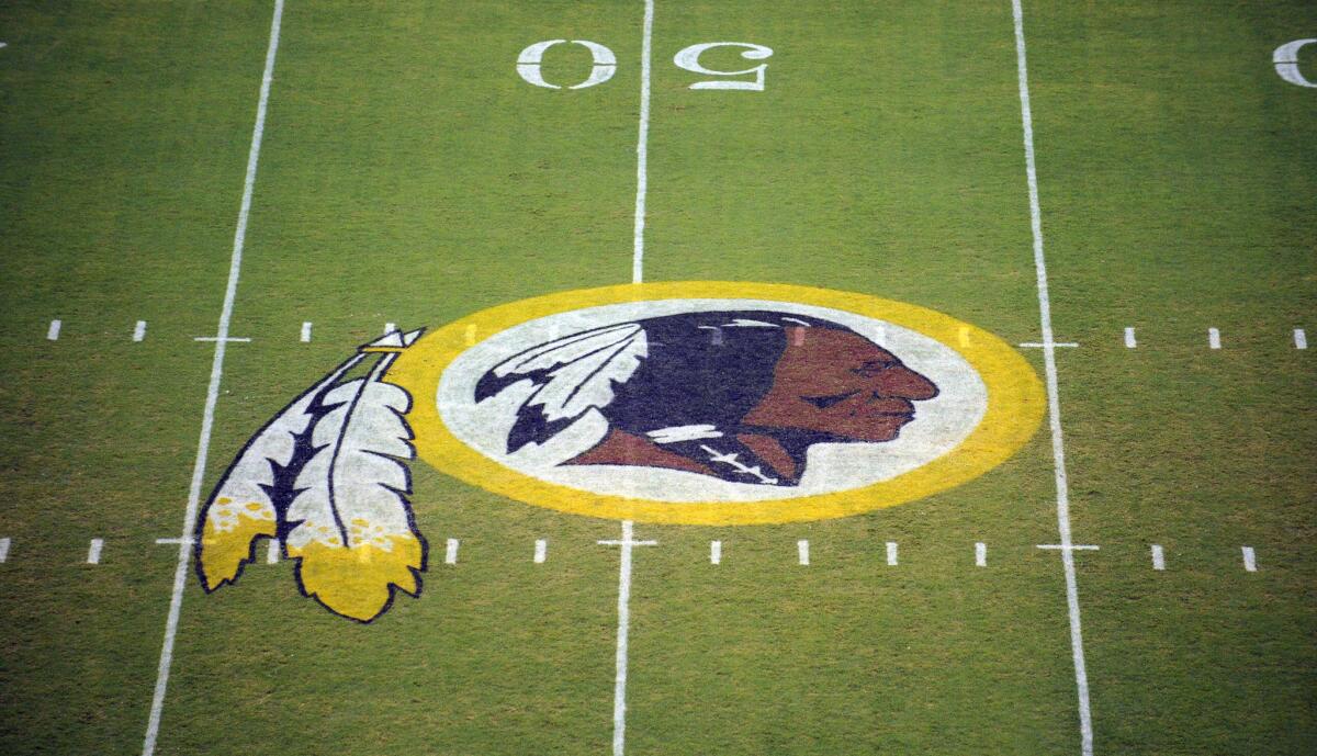 The Washington Redskins logo is seen on the field before the start of a preseason NFL football game in August of 2009.