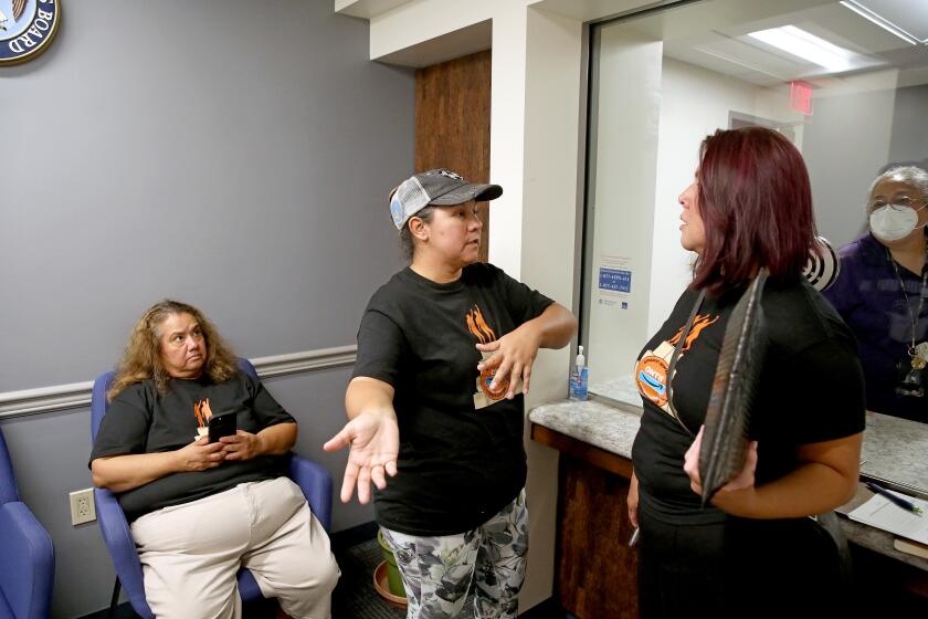 LOS ANGELES, CA - OCTOBER 12: Dyana (cq) Gallo (cq), left, Nannette (cq) Plascencia (cq), 44, union organizer, both Amazon employees at the ONT8 Amazon fulfillment center in Moreno Valley, and Carolina Verduzco, community organizer, file their union election petition at the National Labor Relations Board at the United States Court House in downtown on Wednesday, Oct. 12, 2022 in Los Angeles, CA. (Gary Coronado / Los Angeles Times)