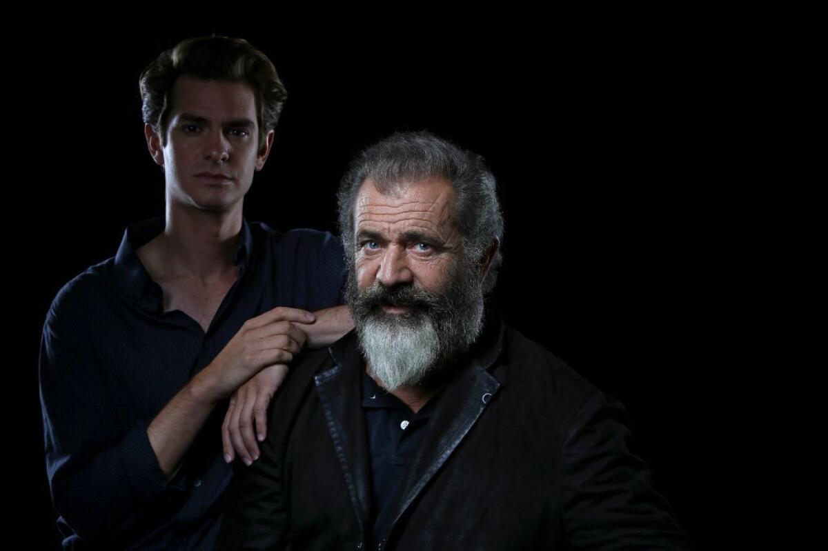 Conscientious objector Desmond Doss risked his life to save others in WWII, "the greatest act of love there is," says director Mel Gibson, right, who tells Doss' story in "Hacksaw Ridge," starring Andrew Garfield.
