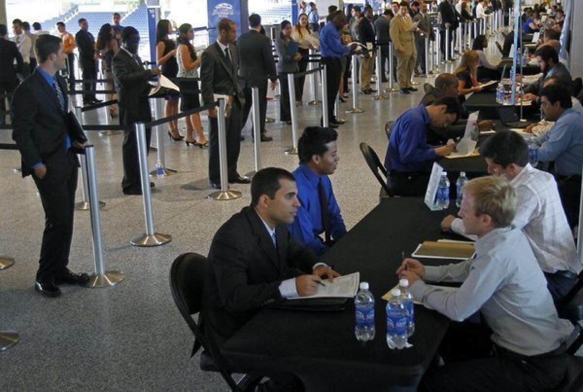 Job applicants are interviewed by Miami Marlins staff in Miami last week. The Labor Department said it was hopeful Hurricane Sandy would not delay Friday's October unemployment report.