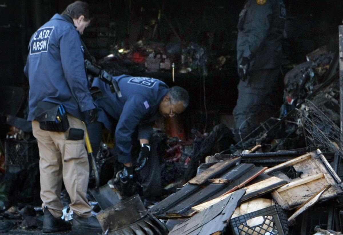 Arson investigators gather evidence in a Winnetka garage, where a man's body was discovered.