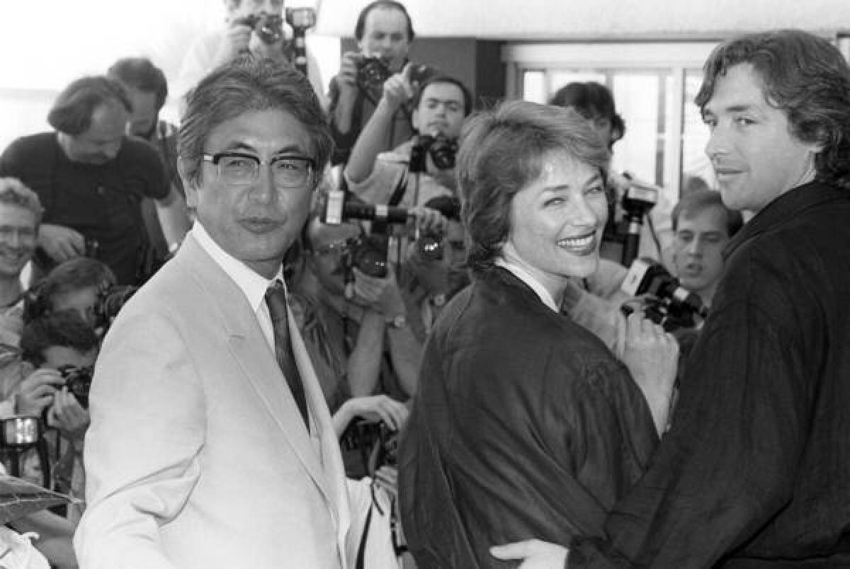 Nagisa Oshima, left, accompanies actors Charlotte Rampling and Anthony Higgins to the presentation of his film "Max Mon Amour" at the Cannes International Film Festival in 1986.