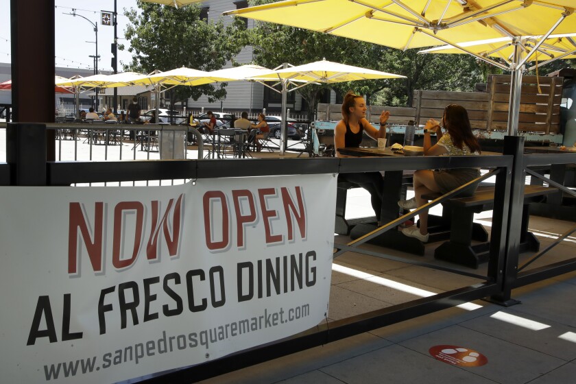 FILE - In this July 6, 2020 file photo, people eat outdoors at San Pedro Square in San Jose, Calif. Tens of thousands of small businesses closed due to the coronavirus pandemic, many of them permanently. Those still standing desperately need community support to stay open or reopen. Among business owners who closed during the pandemic and later reopened, 31% cited customer support as the reason they were able to do s (AP Photo/Ben Margot)