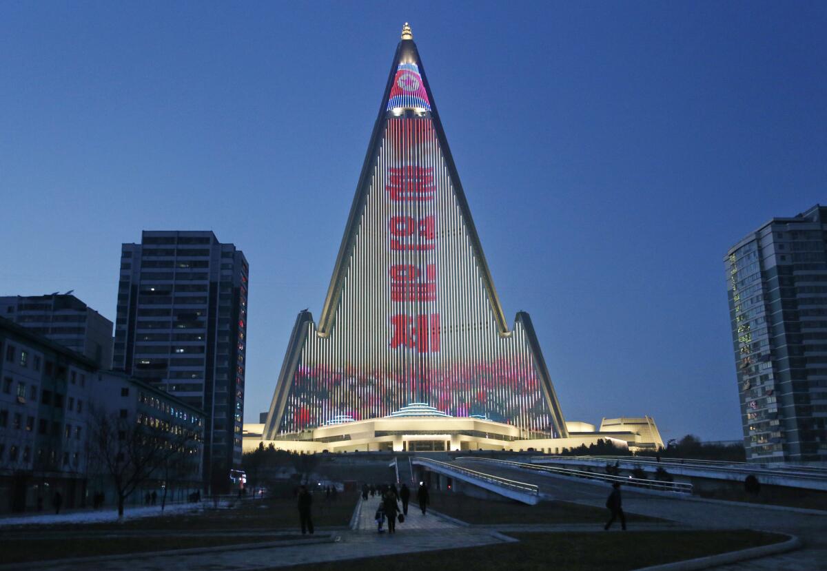 A propaganda message in Korean is displayed on the facade of a mountain-shaped building in Pyongyang. 